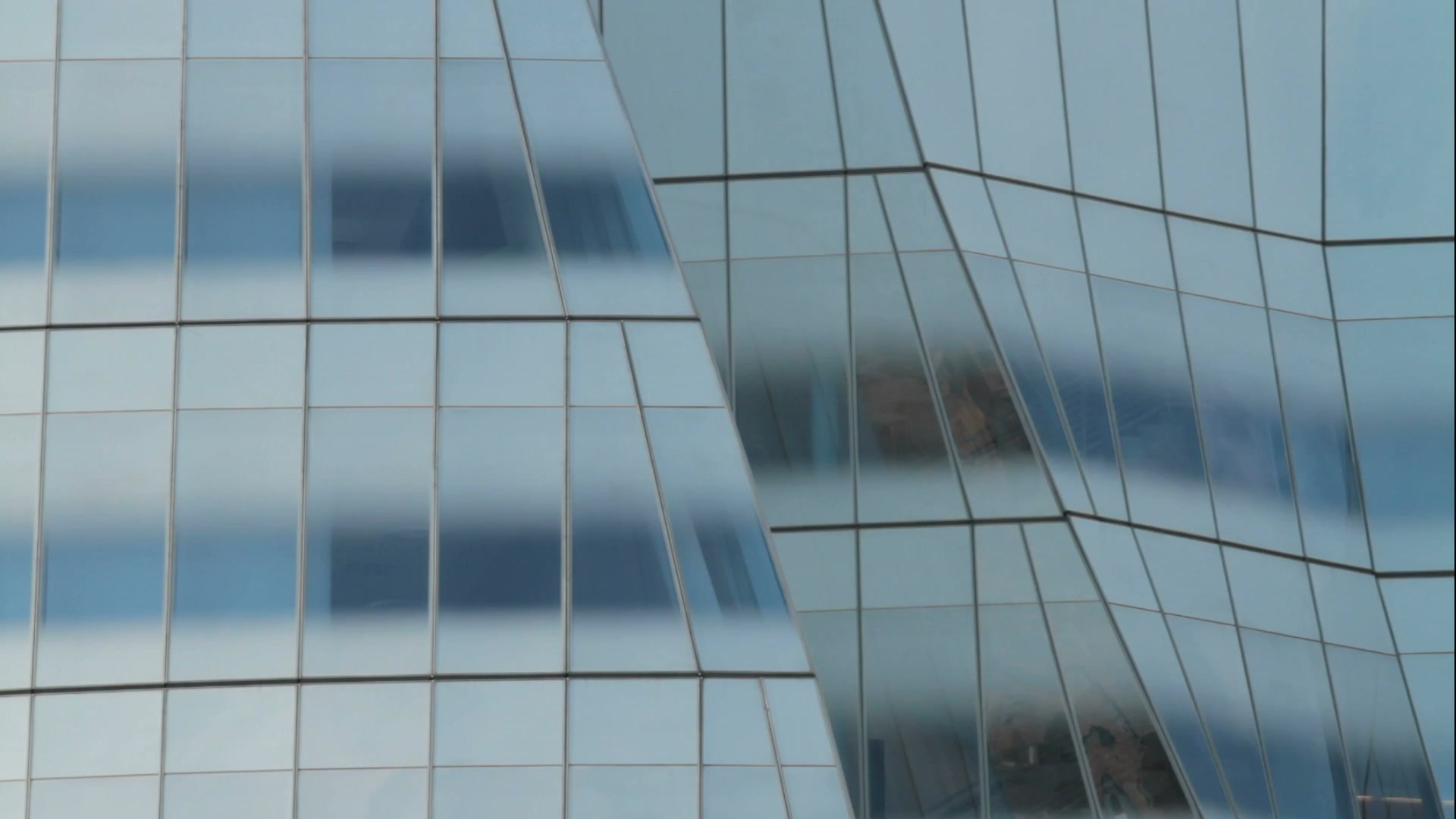 Modern glass building with sweeping architectural lines